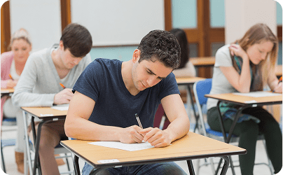 Frame 1618873931 Students concentrating on an exam in classroom.