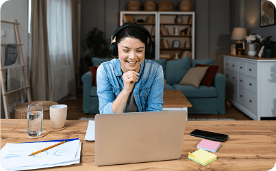 Frame 1618873933 Woman smiling during a video call.